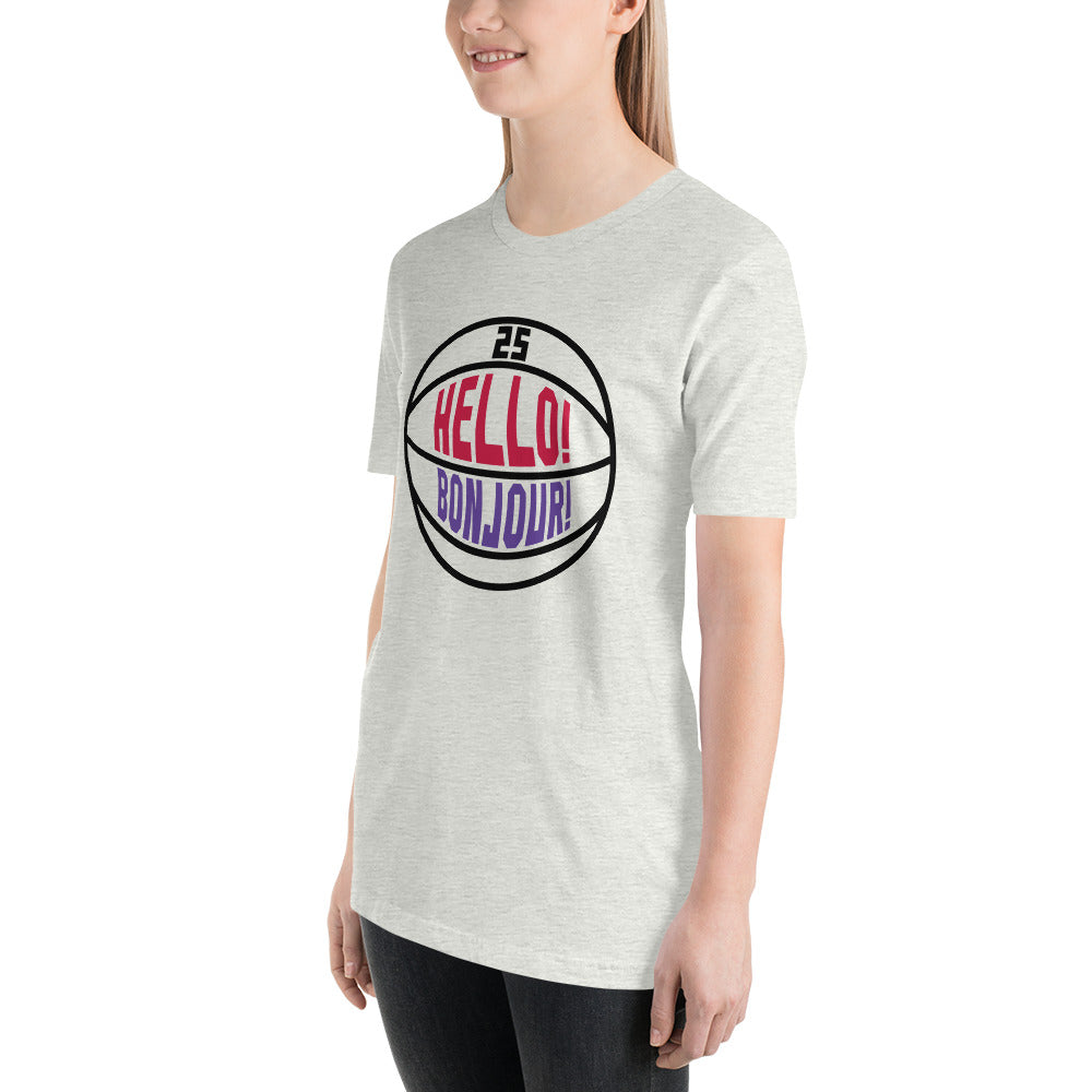 T-shirt worn by young woman, this image details the graphic design "Hello! Bonjour!". In the image, the words are built into a basketball and feature Chris Boucher's number 25. The Toronto Raptors' announcer, Jack Armstrong, loves to shout out Hello! Bonjour! when Chris Boucher does something exciting on the court. The tee is heather ash and the design is black/red/purple similar to the Toronto Raptors retro colours. This item is exclusive to tailgate mercantile and is available only online.