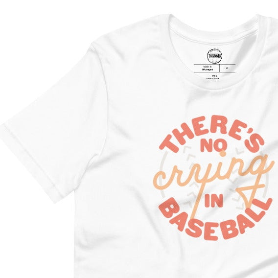 Image of white t-shirt with design of "There's No Crying in Baseball" in peach located on centre chest. There's No Crying in Baseball is an homage to the great AAGPBL women's baseball movie "A League of Their Own". This design is exclusive to Tailgate Mercantile and available only online.