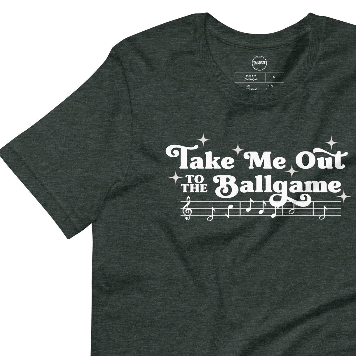 Image of heather emerald green t-shirt with design of "Take Me Out to the Ballgame" with coordinating musical notes in white located on centre chest. This design is exclusive to Tailgate Mercantile and available only online.