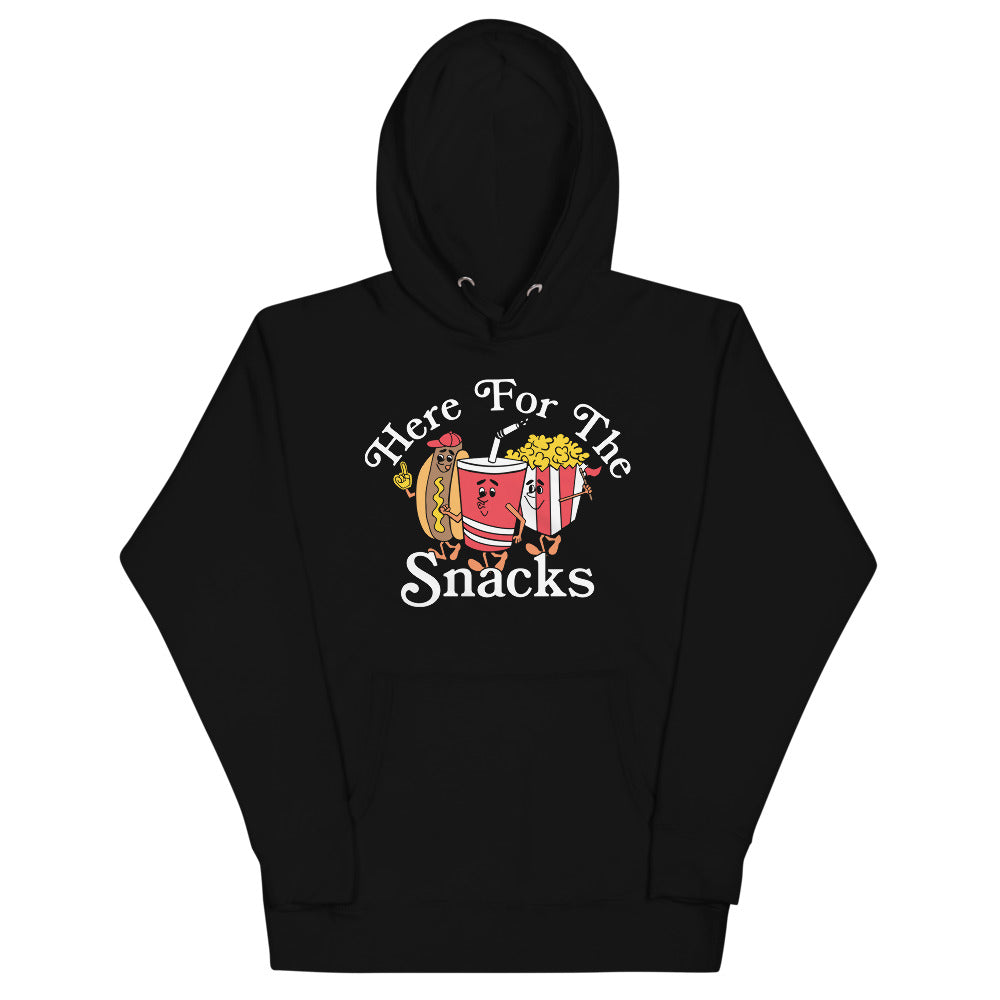 Image of black hoodie with design of "Here For The Snacks" with cartoon hot dog, soda pop and popcorn located on centre chest. This design is exclusive to Tailgate Mercantile and available only online.