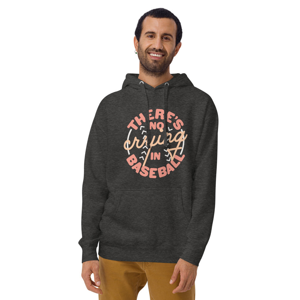 Image of man wearing heather dark grey hoodie with design of "There's No Crying in Baseball" in peach located on centre chest. There's No Crying in Baseball is an homage to the great AAGPBL women's baseball movie "A League of Their Own". This design is exclusive to Tailgate Mercantile and available only online.