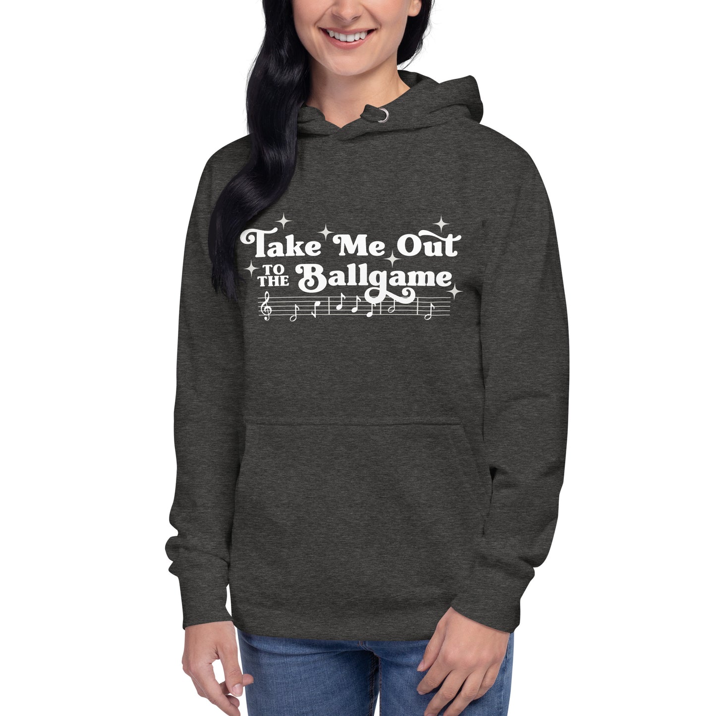 Image of woman wearing heather dark grey hoodie with design of "Take Me Out to the Ballgame" with coordinating musical notes in white located on centre chest. This design is exclusive to Tailgate Mercantile and available only online.