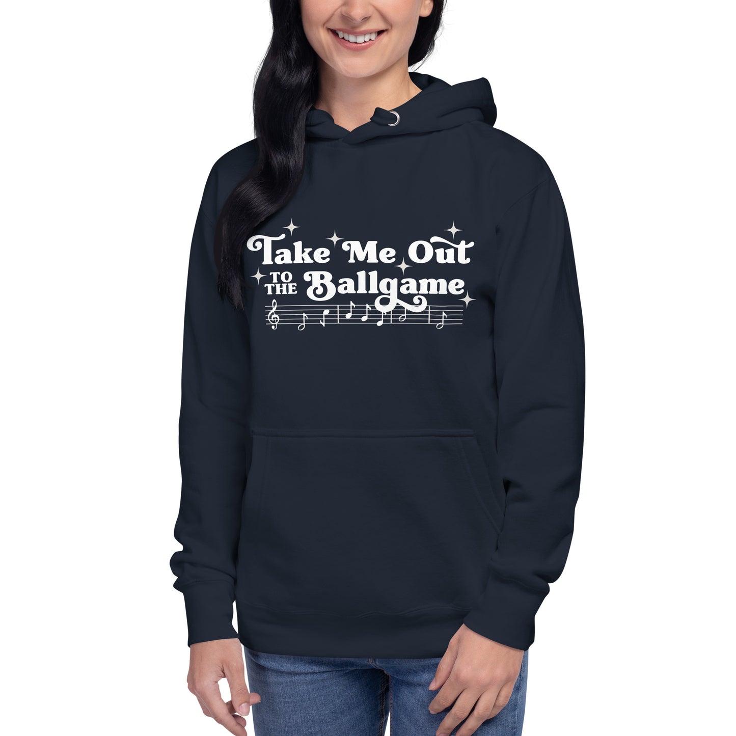 Image of woman wearing navy hoodie with design of "Take Me Out to the Ballgame" with coordinating musical notes in white located on centre chest. This design is exclusive to Tailgate Mercantile and available only online.