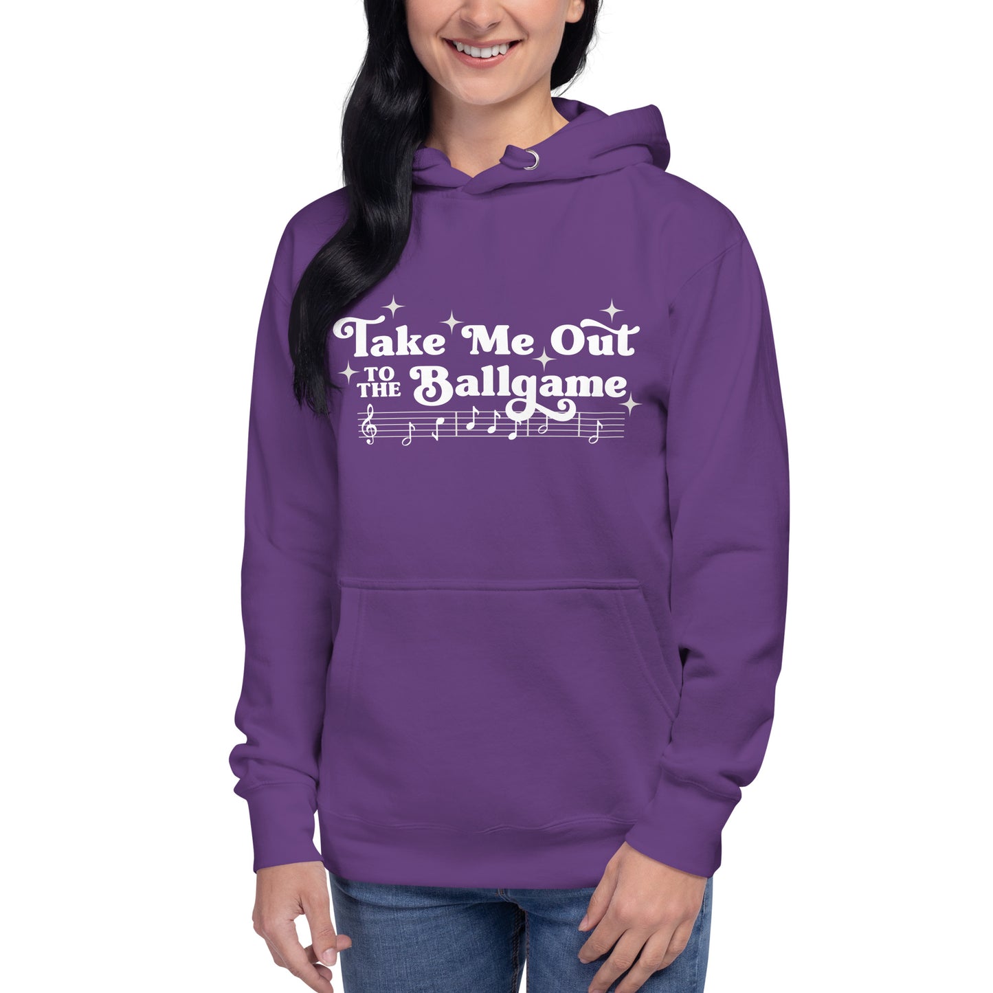 Image of woman wearing purple hoodie with design of "Take Me Out to the Ballgame" with coordinating musical notes in white located on centre chest. This design is exclusive to Tailgate Mercantile and available only online.