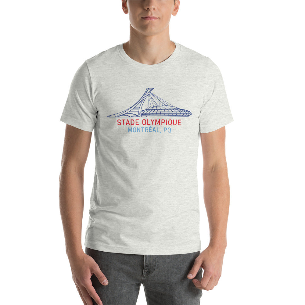 Image of man wearing heather ash t-shirt with design of "Stade Olympique, Montreal, PQ" illustrated ballpark completed in retro Montreal Expos colours located on centre chest. This design is exclusive to Tailgate Mercantile and available only online.