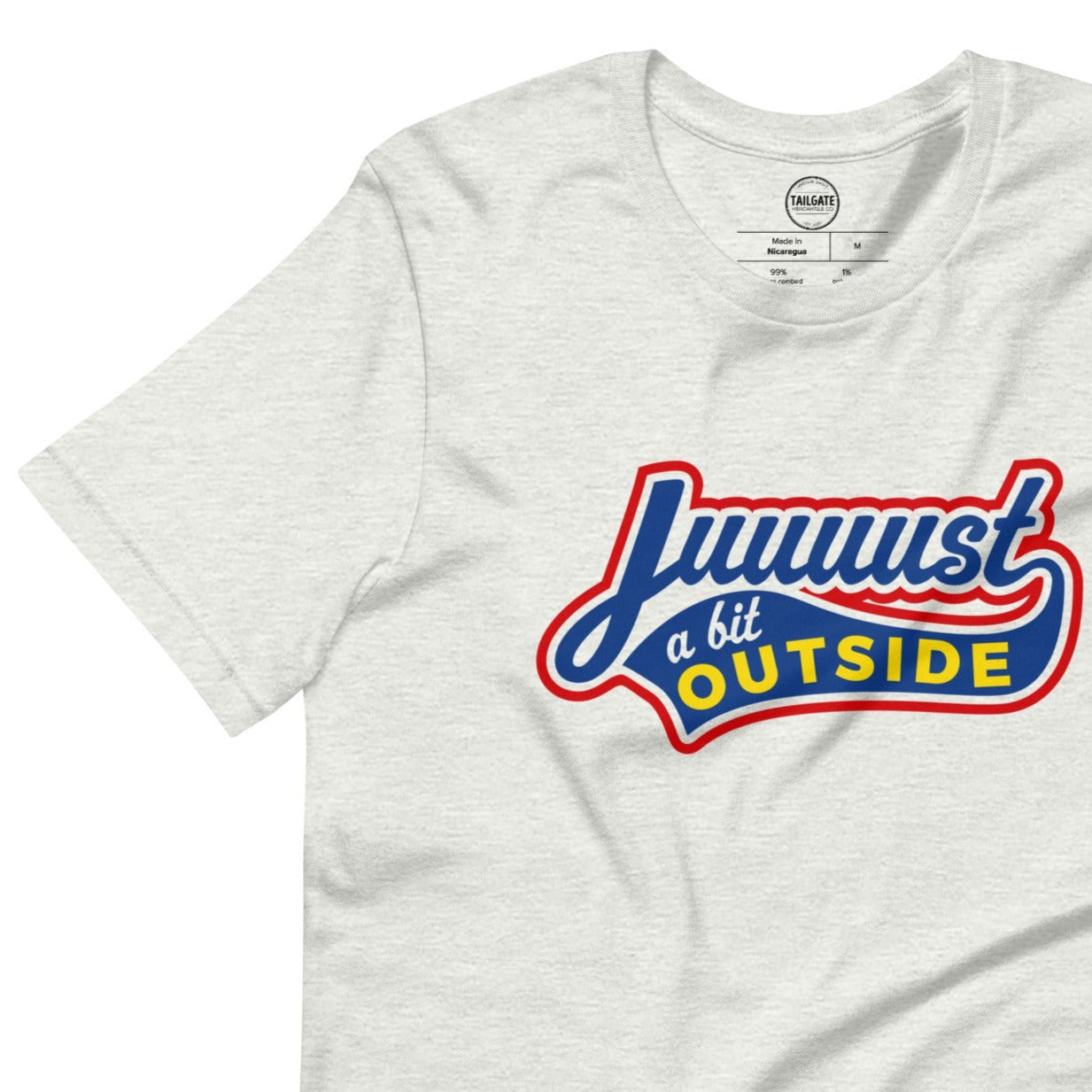 Image of heather ash t-shirt with design of "Juuuust a bit Outside" in blue/red/yellow located on centre chest. Just a Bit Outside is an homage to the great baseball movie "Major League". This design is exclusive to Tailgate Mercantile and available only online.