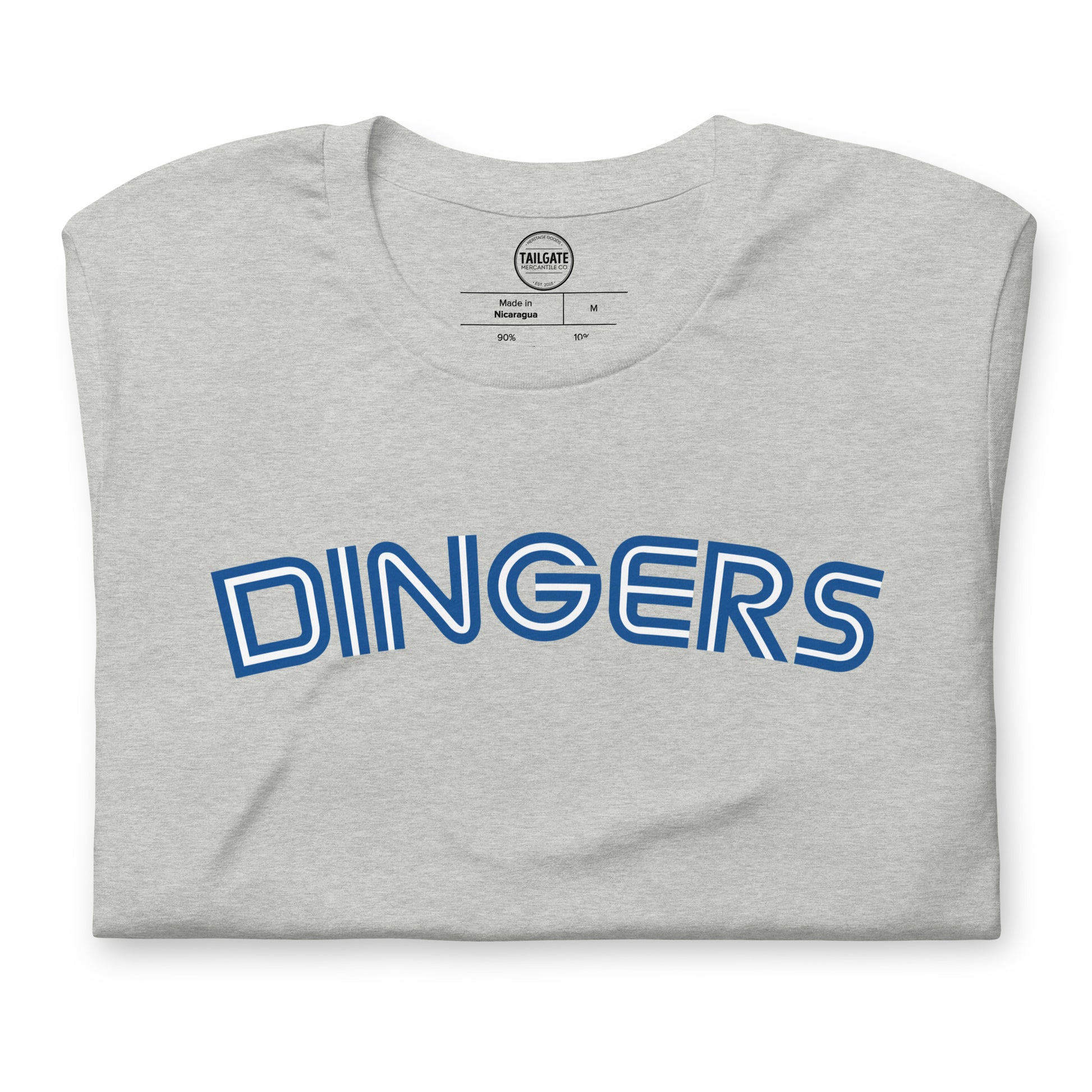 Close up image of heather athletic grey t-shirt with design of "DINGERS" in Toronto Blue Jays retro blue style font located on centre chest. This design is exclusive to Tailgate Mercantile and available only online.