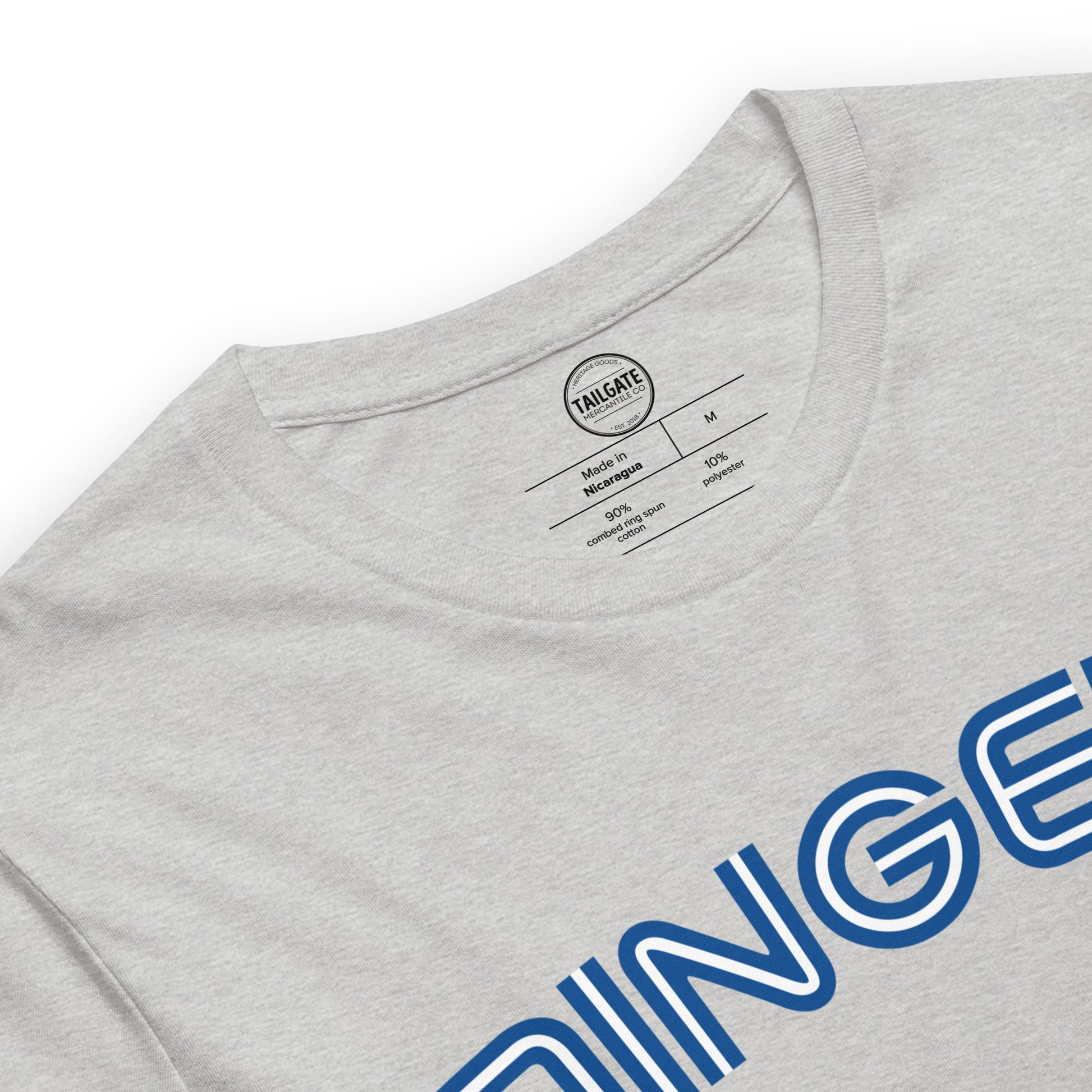 Close up image of heather athletic grey t-shirt with design of "DINGERS" in Toronto Blue Jays retro blue style font located on centre chest. Neck tag information also included in image. This design is exclusive to Tailgate Mercantile and available only online.