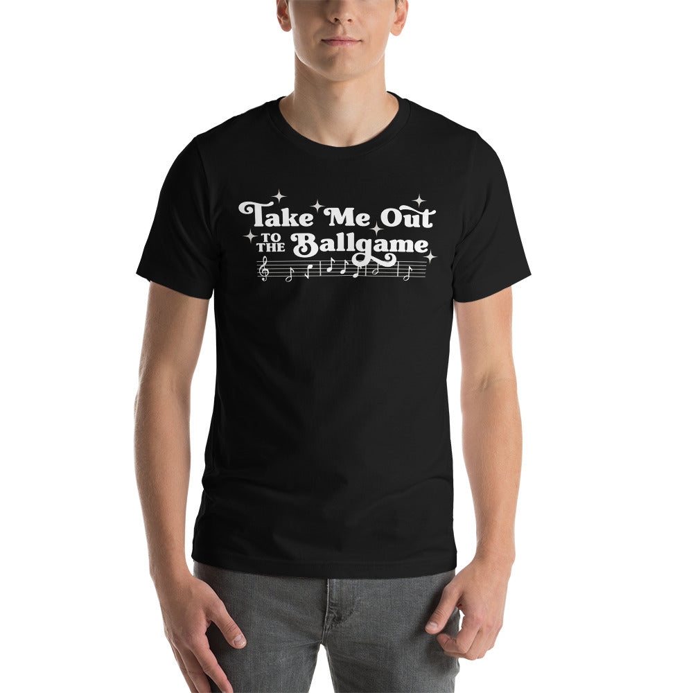 Image of man wearing black t-shirt with design of "Take Me Out to the Ballgame" with coordinating musical notes in white located on centre chest. This design is exclusive to Tailgate Mercantile and available only online.