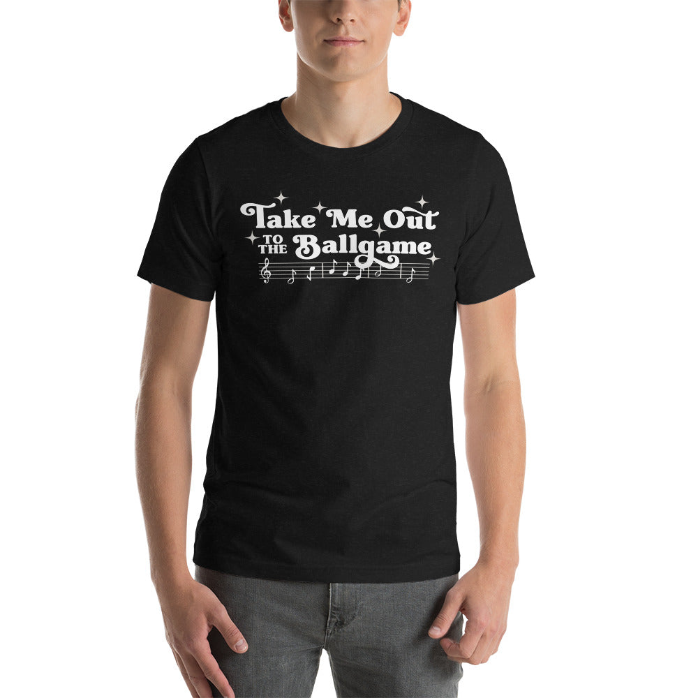 Image of man wearing heather black t-shirt with design of "Take Me Out to the Ballgame" with coordinating musical notes in white located on centre chest. This design is exclusive to Tailgate Mercantile and available only online.
