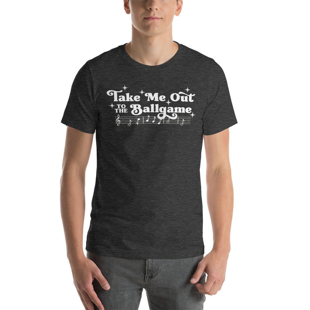 Image of man wearing heather dark grey t-shirt with design of "Take Me Out to the Ballgame" with coordinating musical notes in white located on centre chest. This design is exclusive to Tailgate Mercantile and available only online.
