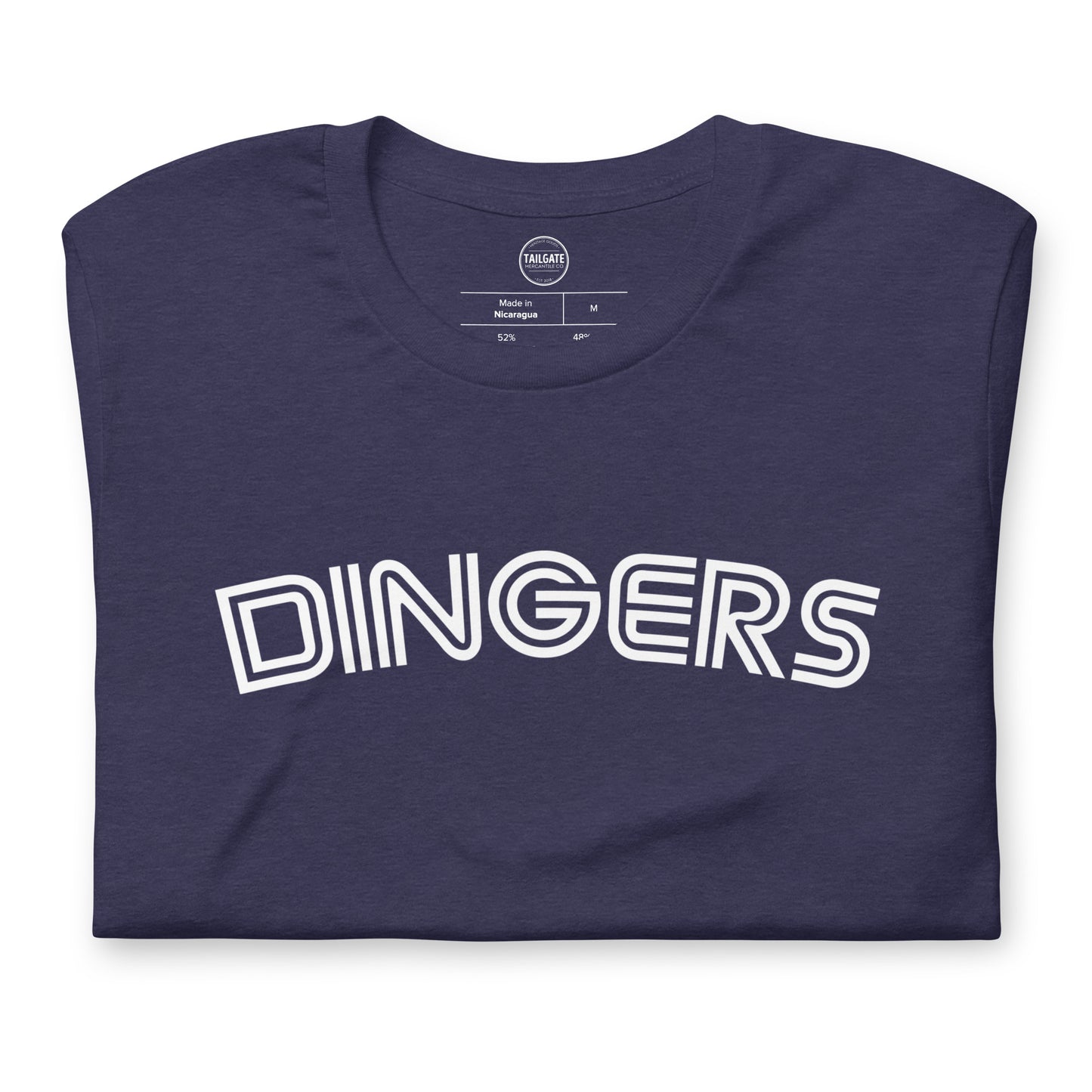 This image details the graphic design of the word "dingers" in a font similar to the Toronto Blue Jays. The font is in white and the tee is navy blue and is a close up of the design. This design is exclusive to tailgate mercantile and available only online.