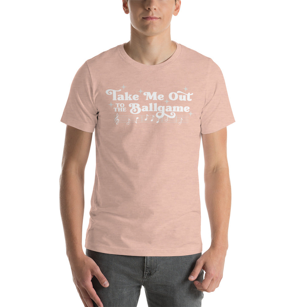 Image of man wearing heather peach t-shirt with design of "Take Me Out to the Ballgame" with coordinating musical notes in white located on centre chest. This design is exclusive to Tailgate Mercantile and available only online.