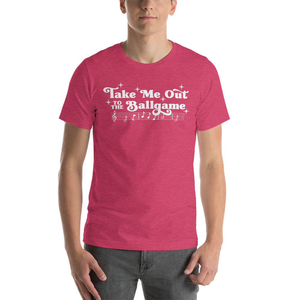Image of man wearing heather pink t-shirt with design of "Take Me Out to the Ballgame" with coordinating musical notes in white located on centre chest. This design is exclusive to Tailgate Mercantile and available only online.