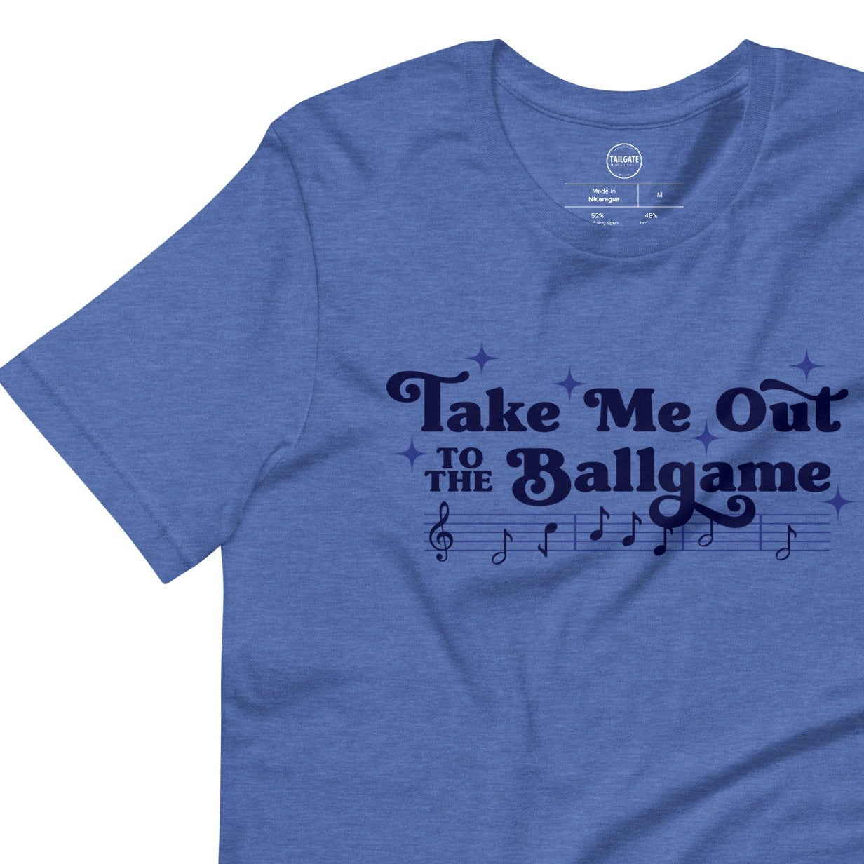 Image of heather royal blue t-shirt with design of "Take Me Out to the Ballgame" with coordinating musical notes in navy located on centre chest. This design is exclusive to Tailgate Mercantile and available only online.