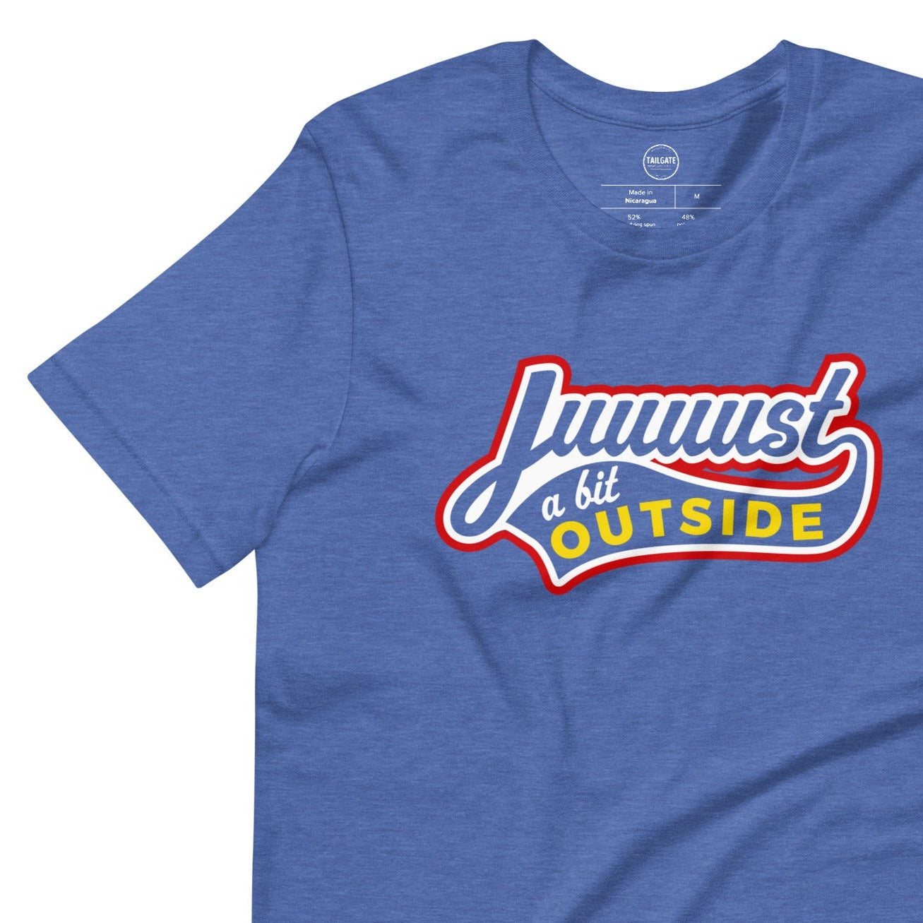 Image of heather royal blue t-shirt with design of "Juuuust a bit Outside" in white/red/yellow located on centre chest. Just a Bit Outside is an homage to the great baseball movie "Major League". This design is exclusive to Tailgate Mercantile and available only online.