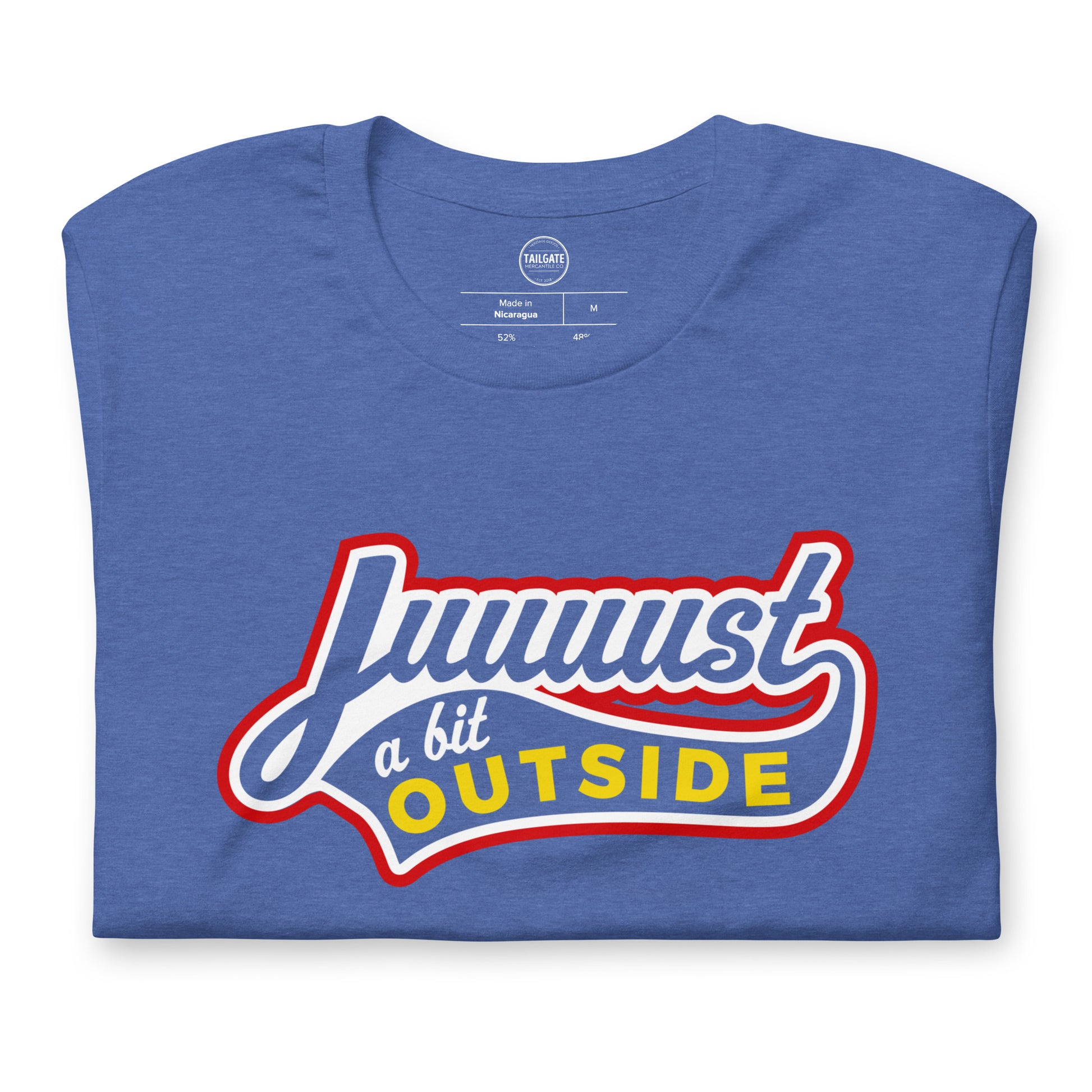 Close up image of heather royal blue t-shirt with design of "Juuuust a bit Outside" in white/red/yellow located on centre chest. Just a Bit Outside is an homage to the great baseball movie "Major League". Image includes neck tag details. This design is exclusive to Tailgate Mercantile and available only online.