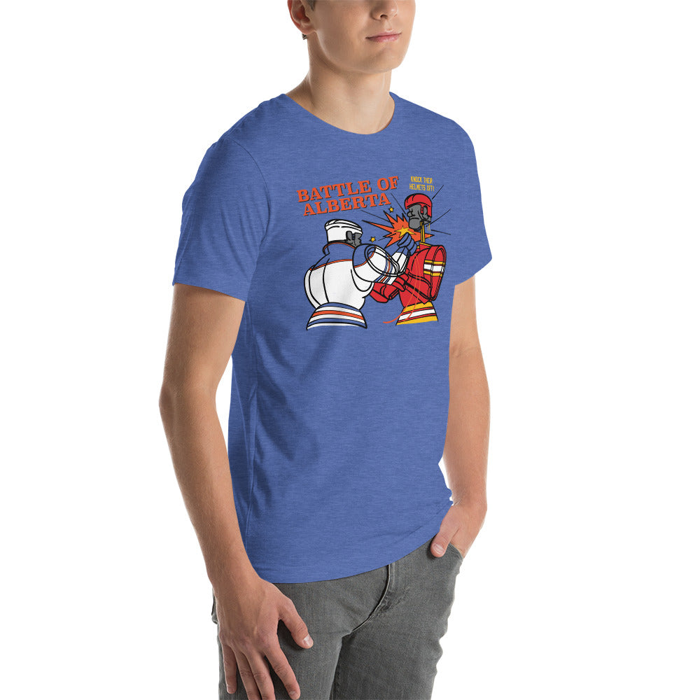 Image of young man wearing heather royal blue t-shirt with design of "Battle of Alberta" with rock'em, sock'em style hockey players fighting located on centre chest. Players in the design are completed in NHL Calgary Flames and Edmonton Oilers colours. This design is exclusive to Tailgate Mercantile and available only online.
