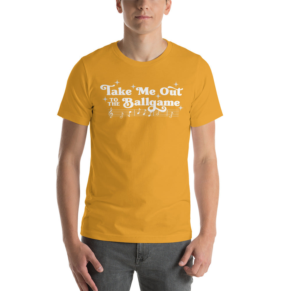 Image of man wearing mustard yellow t-shirt with design of "Take Me Out to the Ballgame" with coordinating musical notes in white located on centre chest. This design is exclusive to Tailgate Mercantile and available only online.