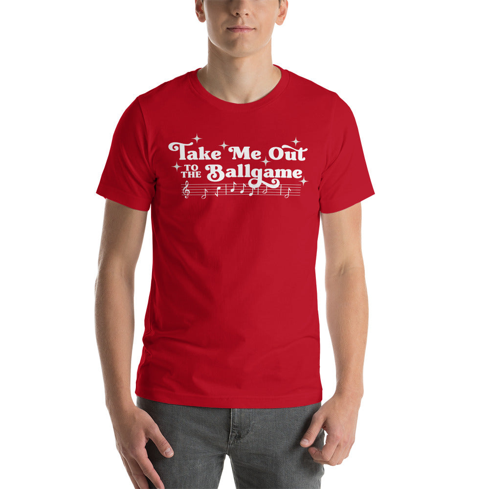 Image of man wearing red t-shirt with design of "Take Me Out to the Ballgame" with coordinating musical notes in white located on centre chest. This design is exclusive to Tailgate Mercantile and available only online.